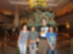 Visiting the Statue of Liberty in 2016, children in front of the original torch on display NYC