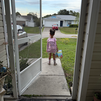 little girl with her backpack walking outside