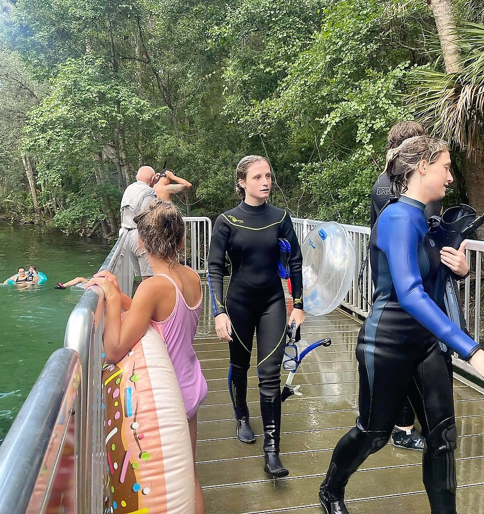 on the deck are snorkelers, and scuba divers 