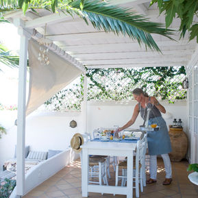 serving breakfast host, pool cafe, garden , palm tree Villa Ippocampi small boutique hotel on Crete in Greece