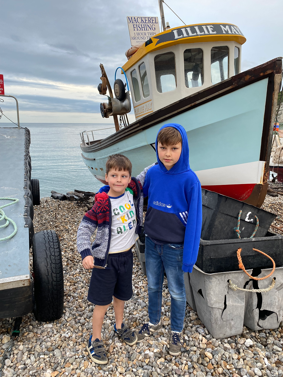 George and William by the Fishing Boats on Beer Beach in Easr Devon