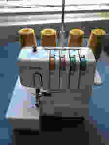 Brother 1034D Overlocker in front of a window on blue mountboard