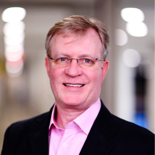 portrait photo of Tom Augenthaler influencer marketing consultant in a pink shirt and black jacket