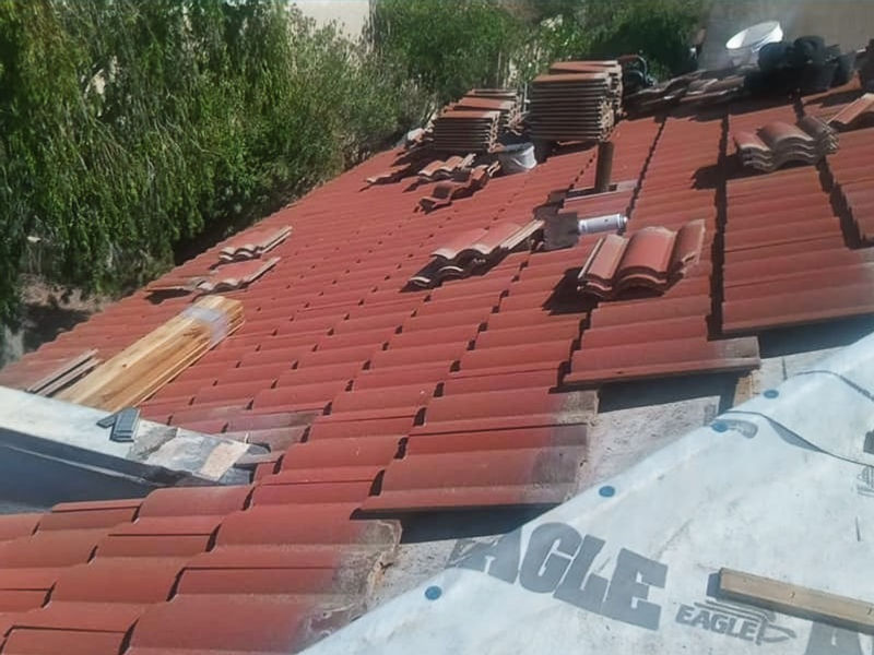 Red concrete tiles going back over new underlayment