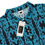 Thumbnail: Men’s slim fit polo, blue lace desing on black