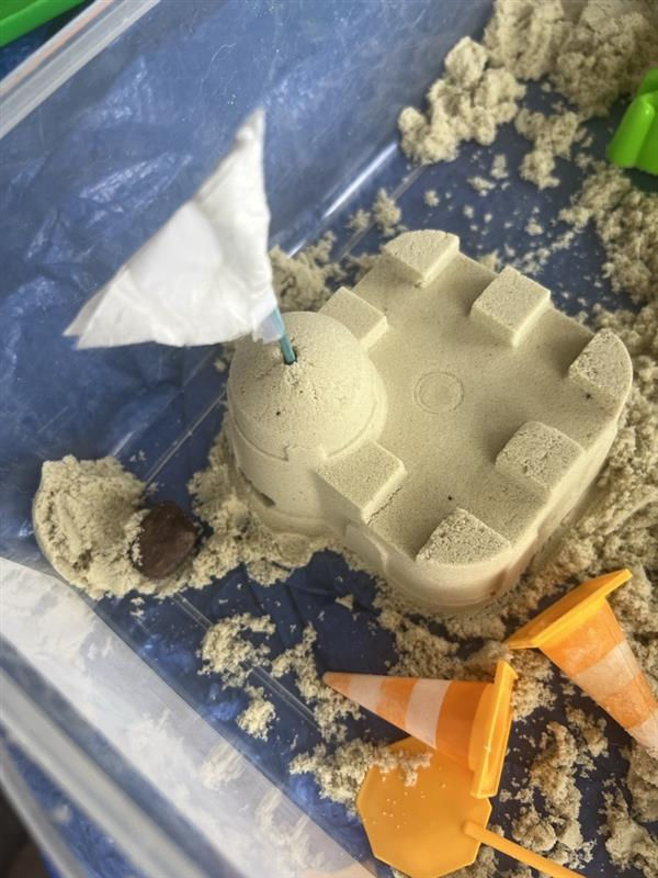 We even created a little DIY flag for his castle with a napkin, some tape, and a toothpick. You can get really creative with a little bit of sand!
