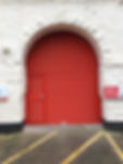 Red shutter fit behind arch with wicket gate