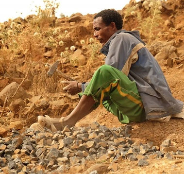 29 Hassan breaking rock by hand for backfill.jpg