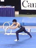 A rhythmic gymnast gymnast about to throw the double rings to do a risk.