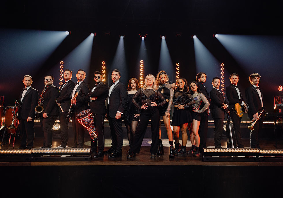 FAYETTE Premium Liveband mit Sängerinnen, Musikern und Bläsern auf einer beleuchteten Bühne.