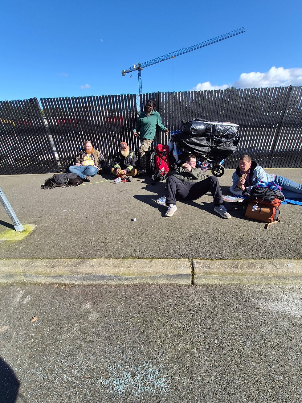 Community members resting together during outreach near downtown Olympia.