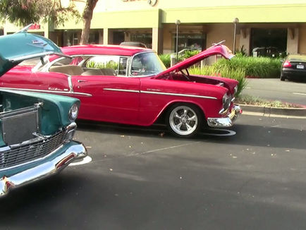 Shows classic cars with hoods up