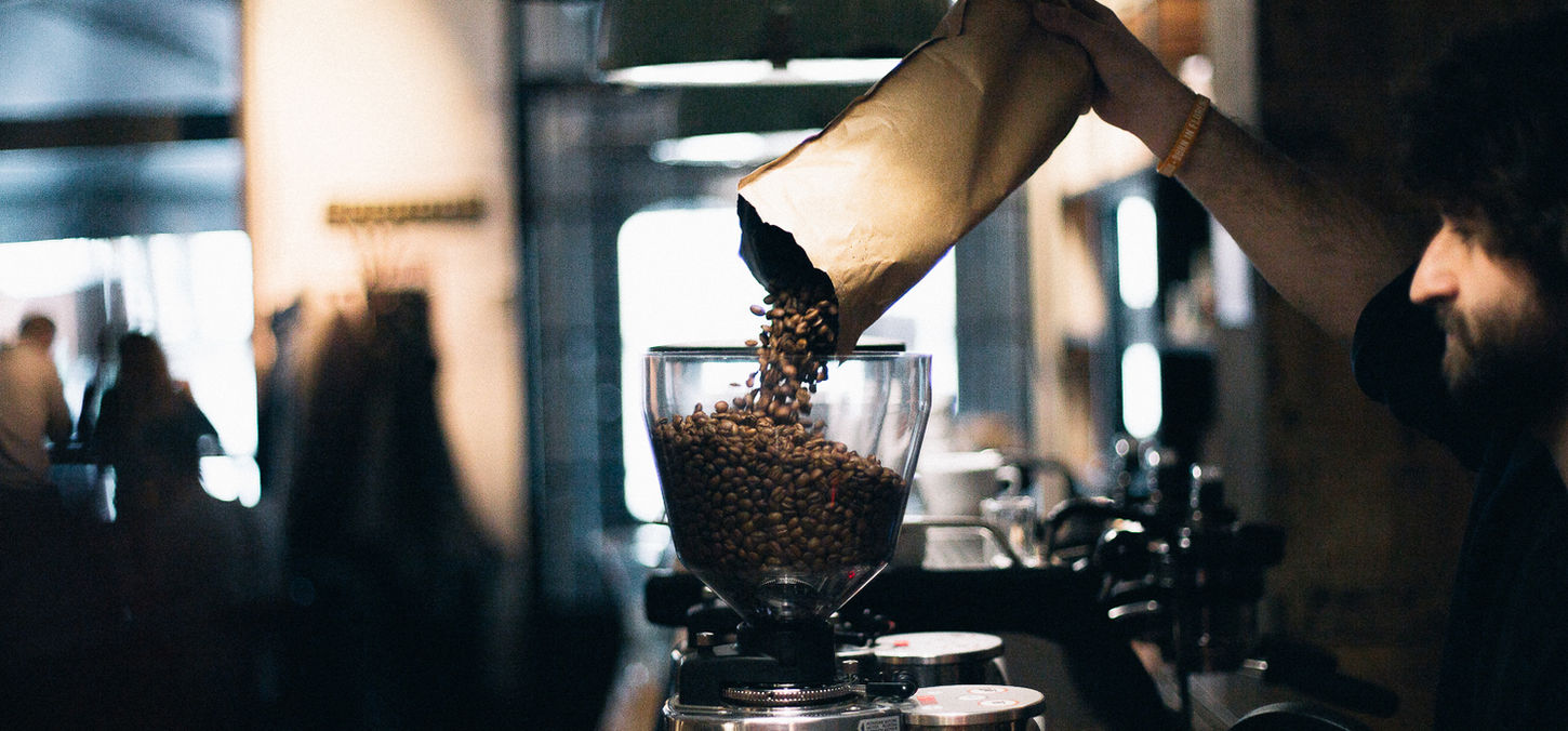 Man Filling up Coffee Beans