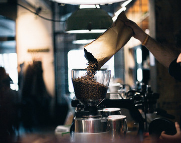 Man Filling up Coffee Beans