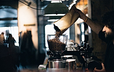 Man Filling up Coffee Beans