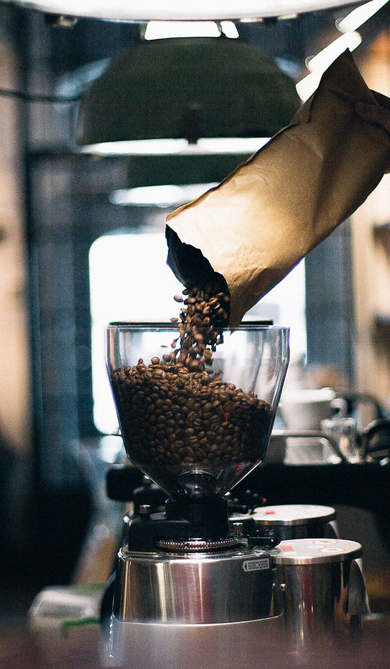 Man Filling up Coffee Beans