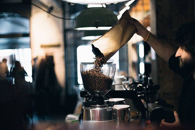 Man Filling up Coffee Beans