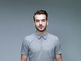 Headshot of Man Wearing a Grey Shirt