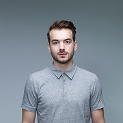 Headshot of Man Wearing a Grey Shirt