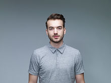 Headshot of Man Wearing a Grey Shirt