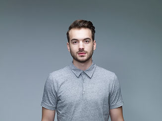 Headshot of Man Wearing a Grey Shirt
