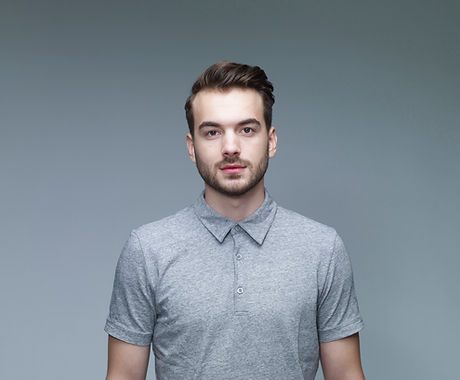 Headshot of Man Wearing a Grey Shirt