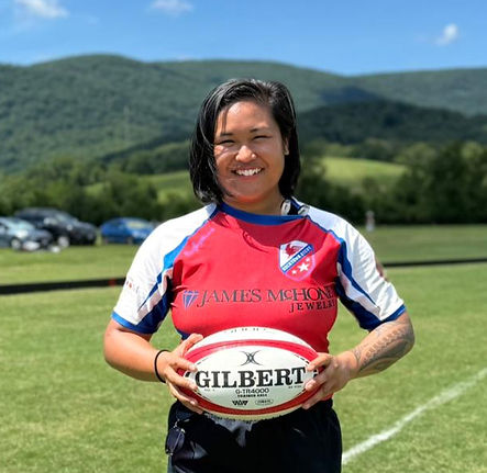 Smiling rugby player holding Gilbert ball