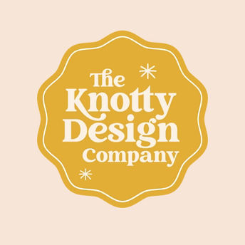 Female owner, sitting on couch, white shirt, pink pants, jars of teas and mugs.