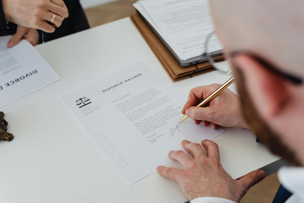 Consultant writing notes beside architectural documents.