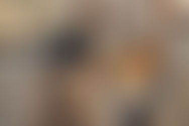 Handyman holding toolbox with tool belt in kitchen