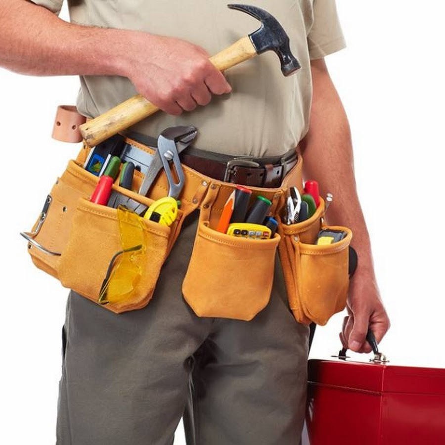 Worker holding a hammer, wearing a tool belt and carrying a toolbox.