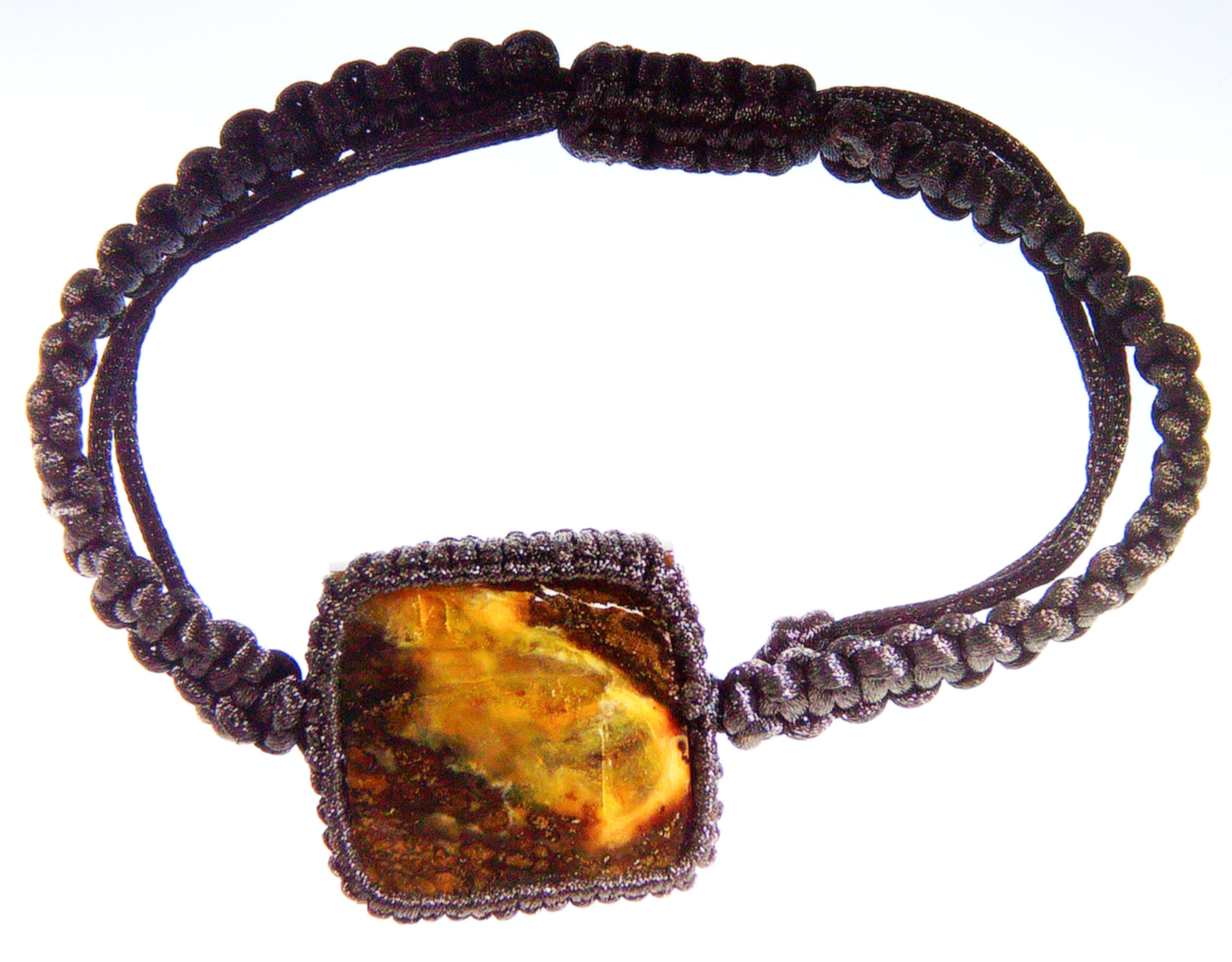 Burmese coffee amber displayed on a light board