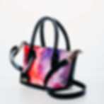 red violet black leather handbag with strap front view