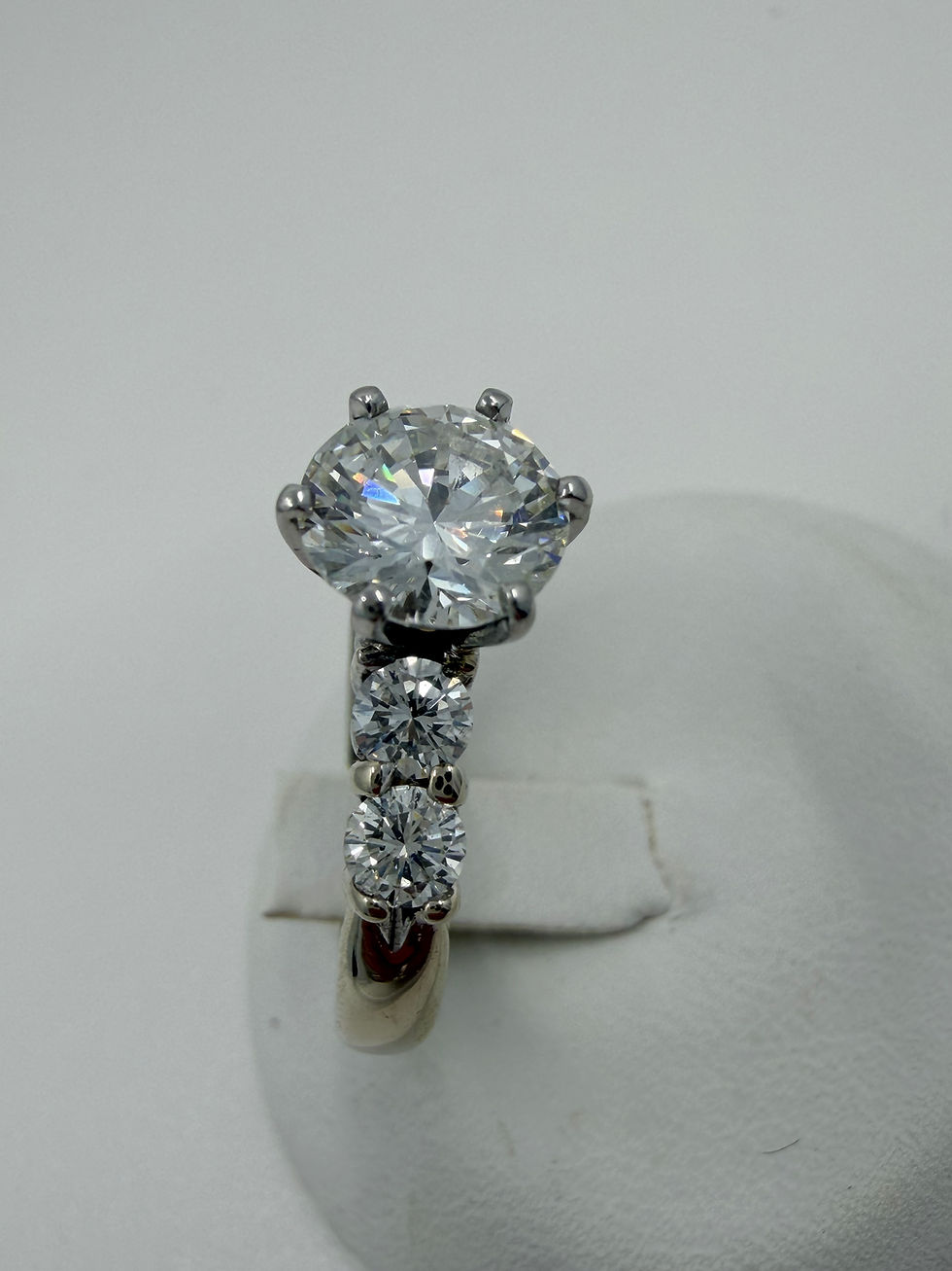 Thumbnail: Round cut diamond engagement ring with side stones.