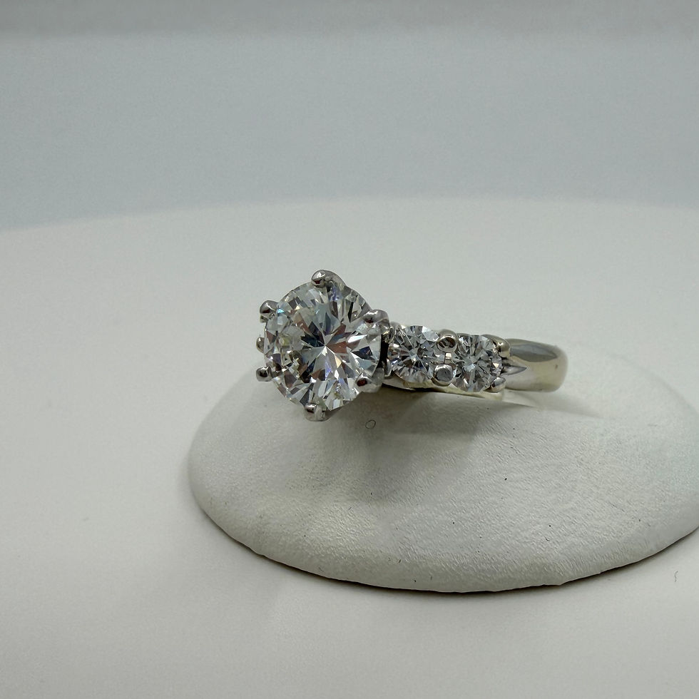 Thumbnail: Round cut diamond engagement ring with side stones.
