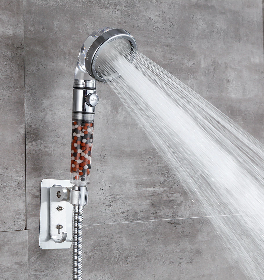 The water saving, luxurious, and pet friendly StoneStream EcoPower shower head in massage setting in a grey tiled bathroom.