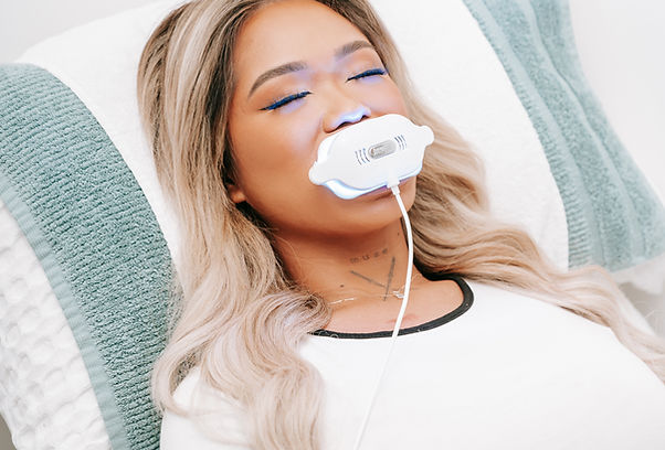 Client receiving professional teeth whitening at Pure Aesthetics Clinic Mandurah using our exclusive plant-based whitening ge