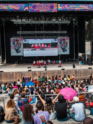 Dancing out of passion, competing out of ambition — this vibrant spirit encapsulates the essence that drives K-Pop dancers across Europe and inspired Comicon's European K-Pop Dance Fight Fest. These dedicated performers often begin their journeys in the privacy of their own bedrooms, imitating the intricate choreography of their beloved Korean idols while playing games like Just Dance. What starts as a solitary experience evolves into a communal expression as they gather in parking lots and town squares, speakers in hand, reminiscent of the break-dancers who transformed urban spaces three decades ago.
