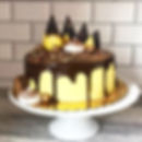 Yellow and dark chocolate ganache drip cake with chocolate shards
