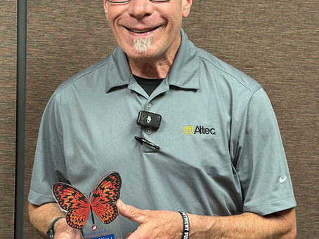 Bill Edwards smiles while holding his Freudenthal Home-Based Healthcare Aging Well Award after being named the June 2026 recipient.