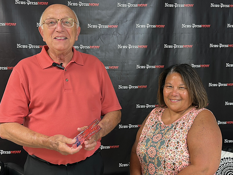George Szczepanik and Bibi Miller smiling together, holding the Aging Well Award trophy.