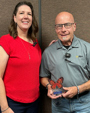 Leah Garcia presents the Freudenthal Home-Based Healthcare Aging Well Award to June recipient Bill Edwards during a recognition ceremony.