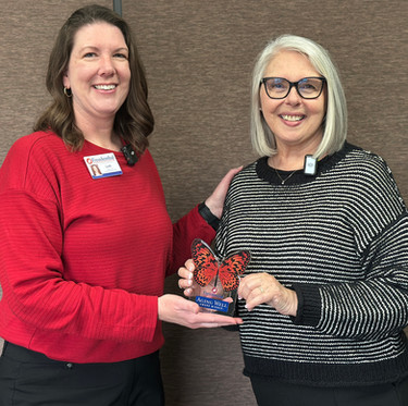 Leah and Melody Smith smiling together while holding the Freudenthal Aging Well Award, celebrating Melody as the March award winner.