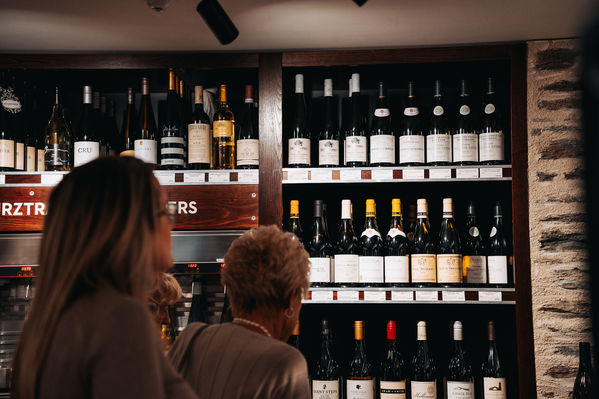 Guests enjoying premium wine tasting at an iconic wine store in Arrowtown The Winery  in Arrowtown during a Latitude 45 luxury wine tour from Queenstown.