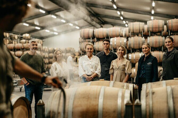 Guests enjoying a private vineyard tour at an exclusive vineyard in Central Otago during a Latitude 45 luxury wine tour from Queenstown.