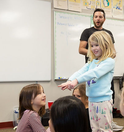 An elementary classroom filled with kids being taught by Drama Lab founder Aaron Strawn.