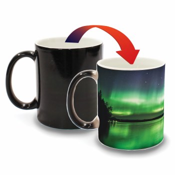 Minnesota Color-Changing Mug - Northern Lights. Two coffee mugs with red arrow pointing from left mug to right mug. Left mug is black. Right mug has colorful image of Northern Lights scenery.