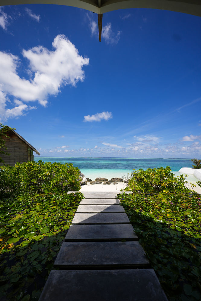 A garden path opening onto the lagoon at Ozen Life Maadhoo