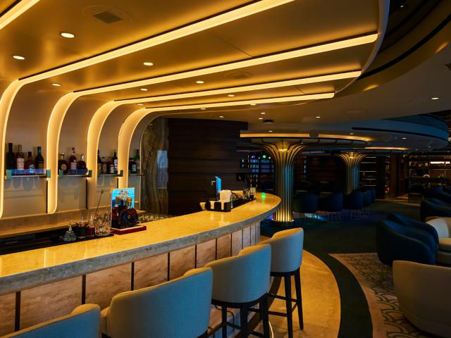 Modern bar lounge with warm lighting on Explora II.