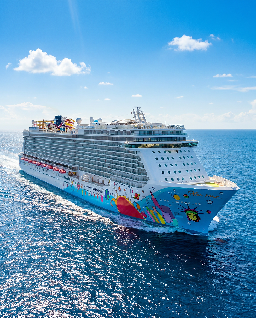 Norwegian Cruise Line ship sailing on sunny blue waters.